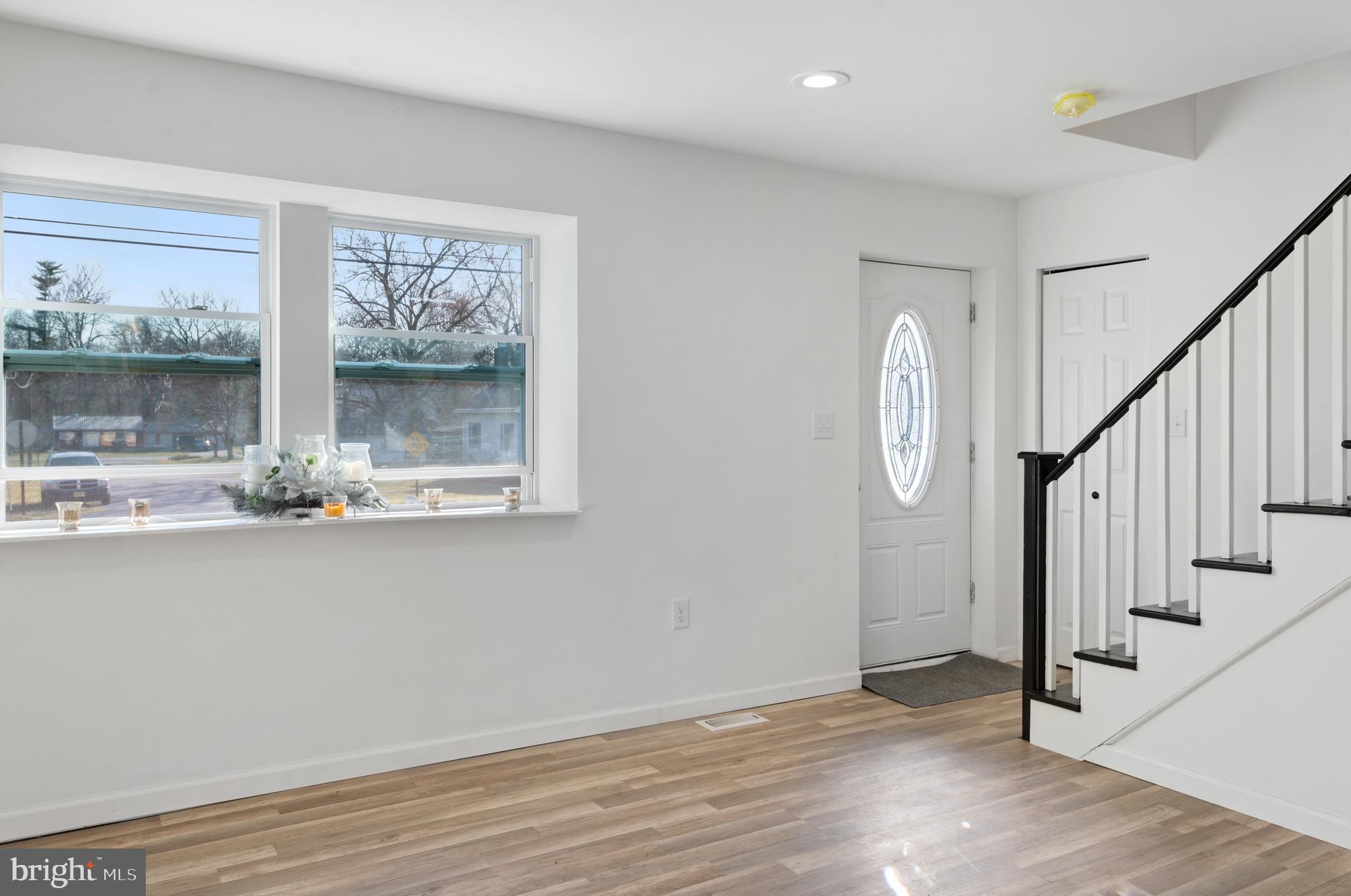 129 Marlton Road Pilesgrove, NJ 08098 - Photo 4 of 27 a view of a hallway with wooden floor and staircase
