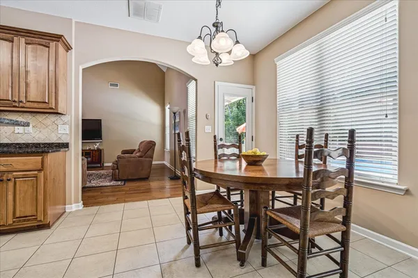 a view of a dining room with furniture and a chandelier