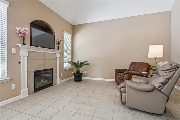 a living room with furniture and a fireplace