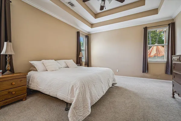 a bed sitting in a bedroom next to a window