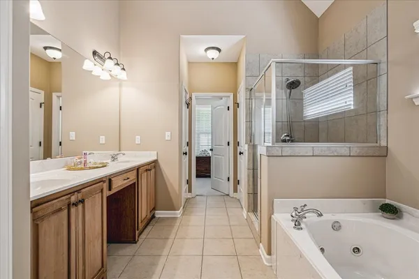 a bathroom with a tub sink and mirror