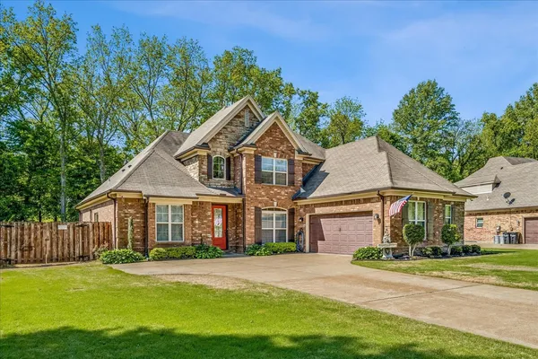 a front view of a house with a yard