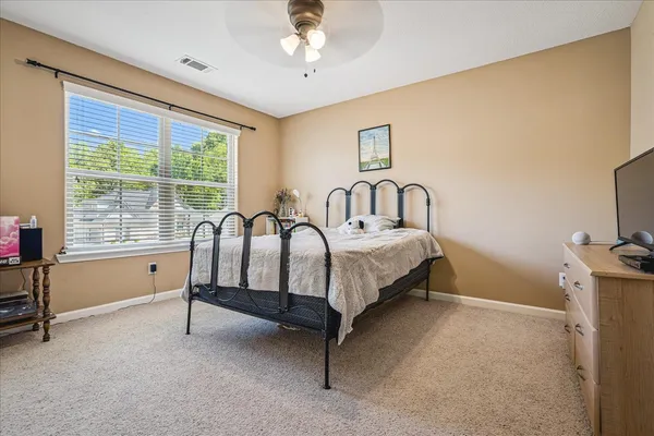 a bed sitting in a room next to a window