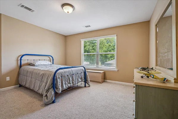 a bedroom with a bed and a window