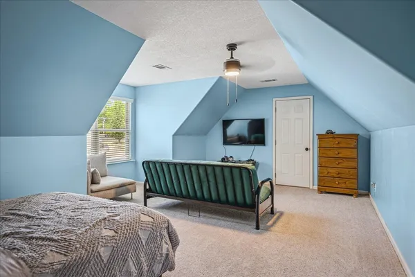 a bedroom with furniture and a window