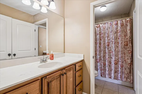 a bathroom with a sink mirror and a shower