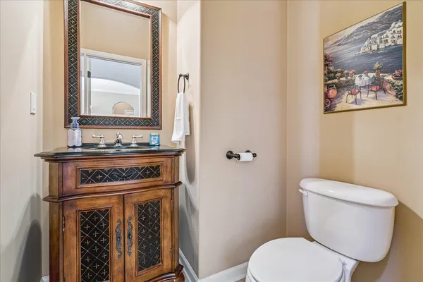 a white toilet sitting next to a bathroom sink