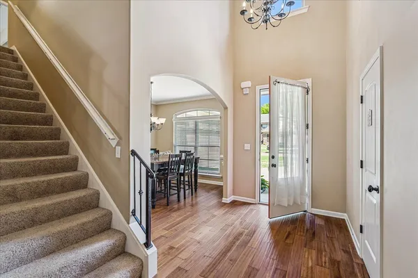 a view of a hallway with wooden floor and staircase