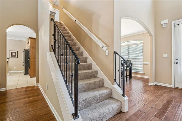 a view of entryway and hall with wooden floor