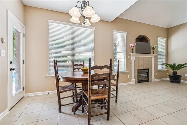a view of a dining room with furniture and chandelier