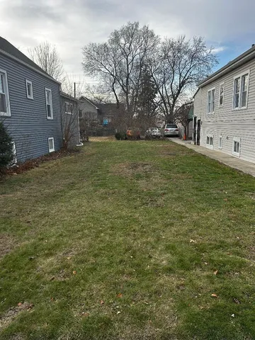 a brick house that has a tree in front of it