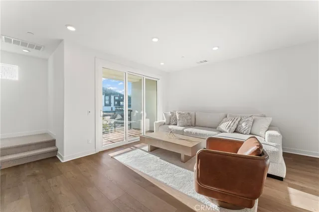 a living room with furniture and kitchen view