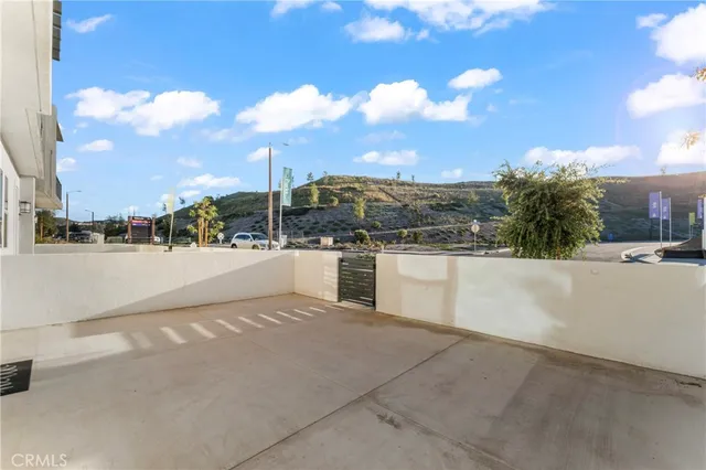 a view of a hallway with wooden floor and entryway