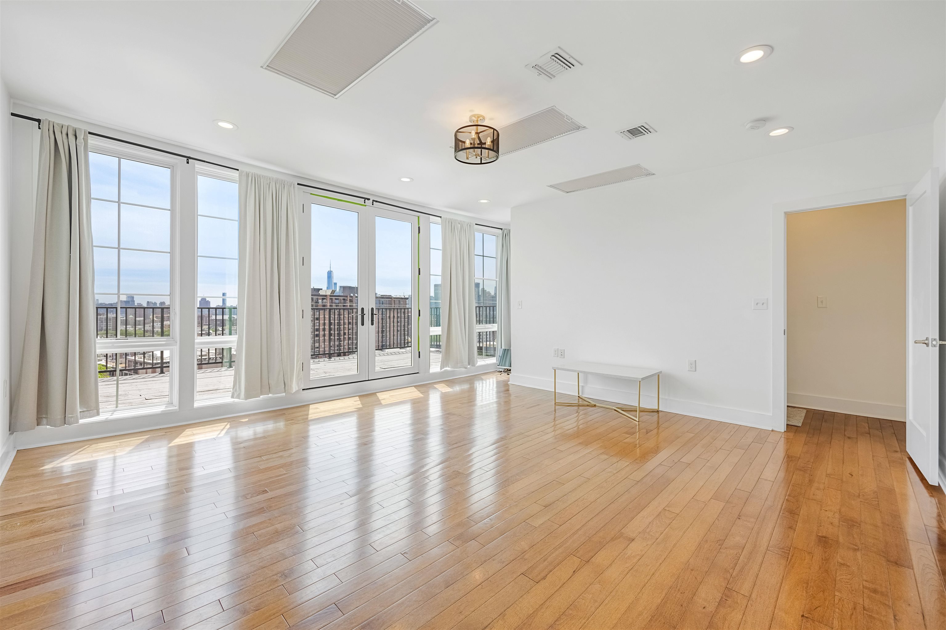 107 Mountain Road Jersey City, NJ 07307 - Photo 16 of 41 a view of an empty room with wooden floor and a window