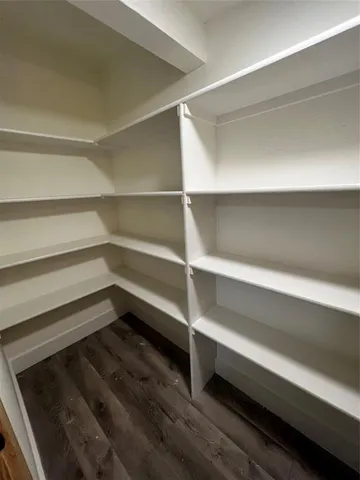 a view of walk in closet with empty racks