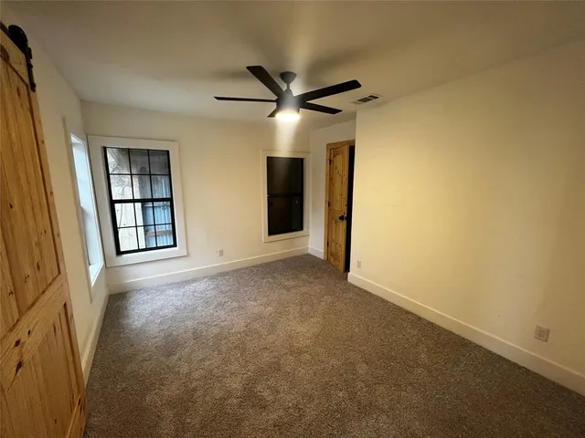 wooden floor in an empty room with a large window