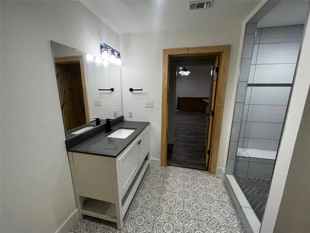 a bathroom with a sink and a mirror