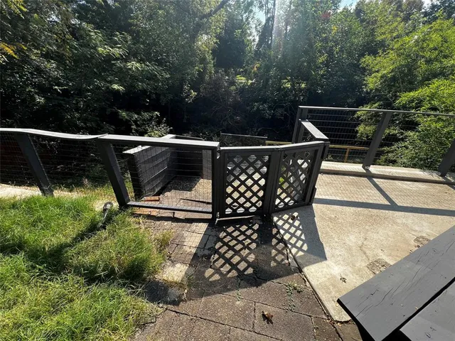 a view of a roof deck with wooden floor and bench