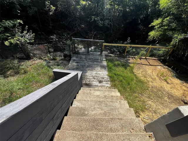 a view of swimming pool with chairs in patio
