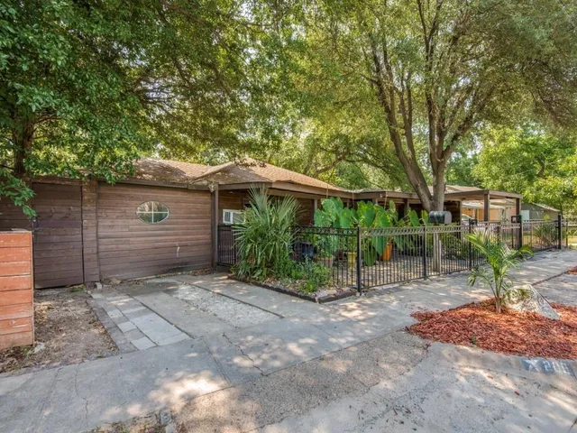 a backyard of a house with plants and trees