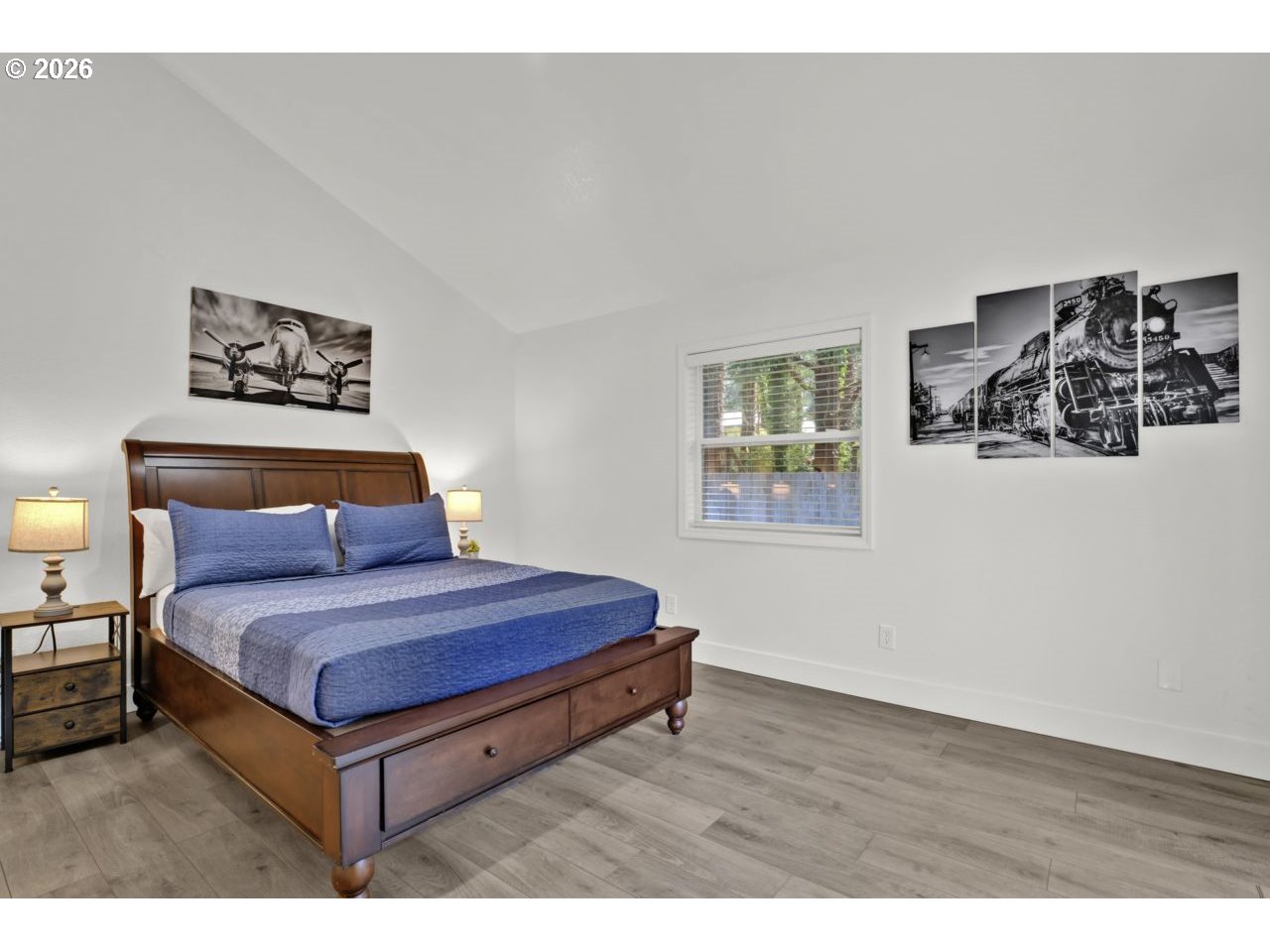 4847 Darlings Loop Florence, OR 97439 - Photo 17 of 47 a bedroom with a bed and wooden floor