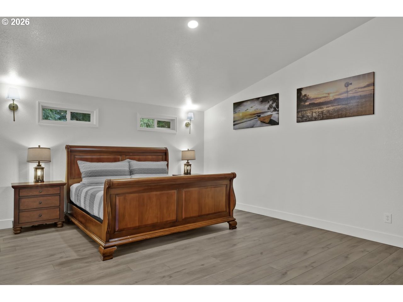 4847 Darlings Loop Florence, OR 97439 - Photo 26 of 47 a spacious bedroom with a bed and a night stand