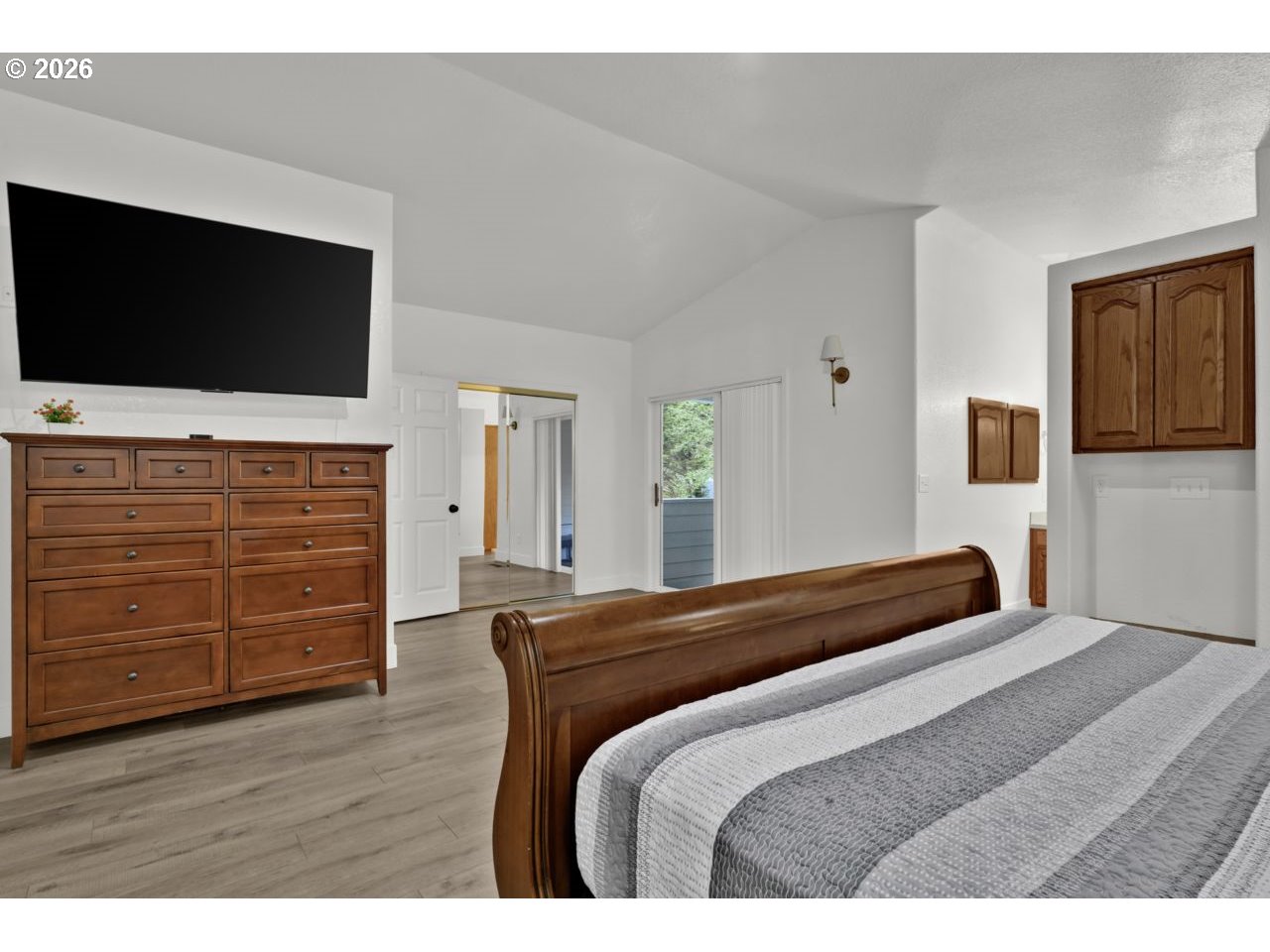 4847 Darlings Loop Florence, OR 97439 - Photo 27 of 47 a bedroom with a bed and flat screen tv
