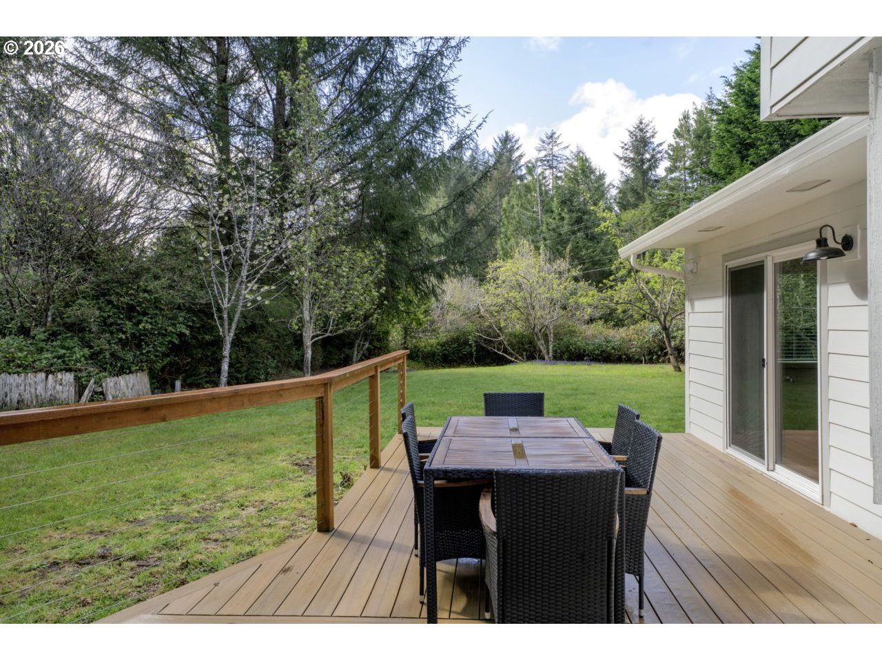 4847 Darlings Loop Florence, OR 97439 - Photo 42 of 47 a view of a patio with a table chairs and a backyard