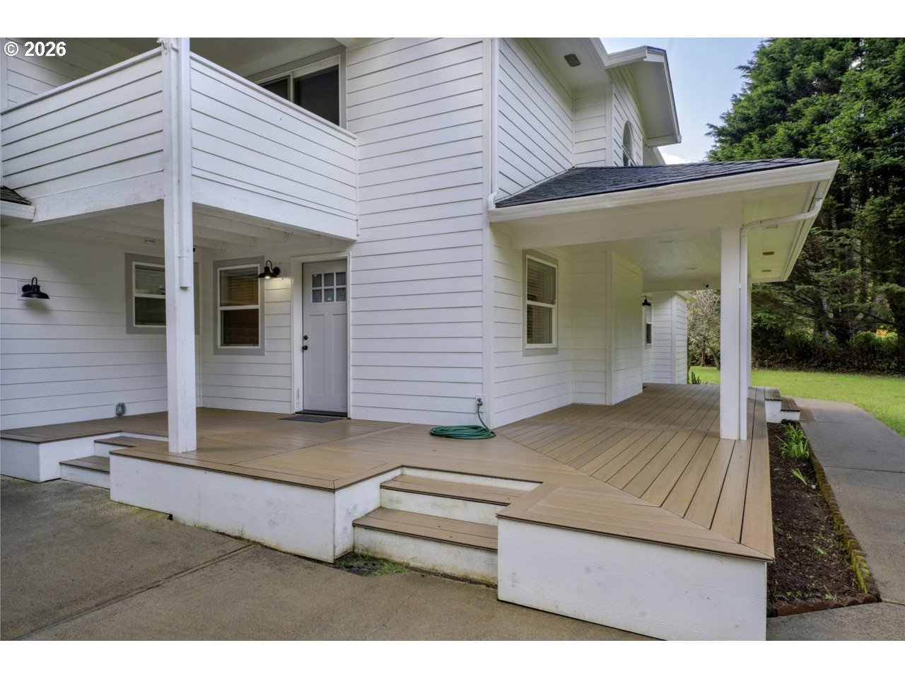 4847 Darlings Loop Florence, OR 97439 - Photo 5 of 47 a view of house with backyard and outdoor seating
