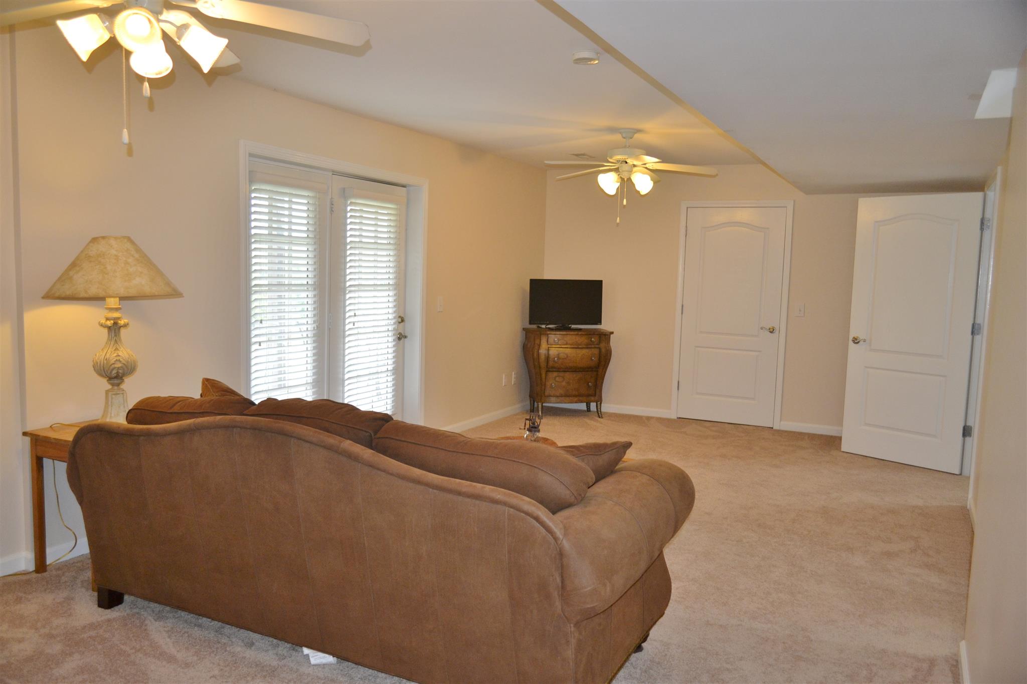 1905 Clara Mathis Road Spring Hill, TN 37174 - Photo 24 of 29 a living room with furniture a lamp and a chandelier