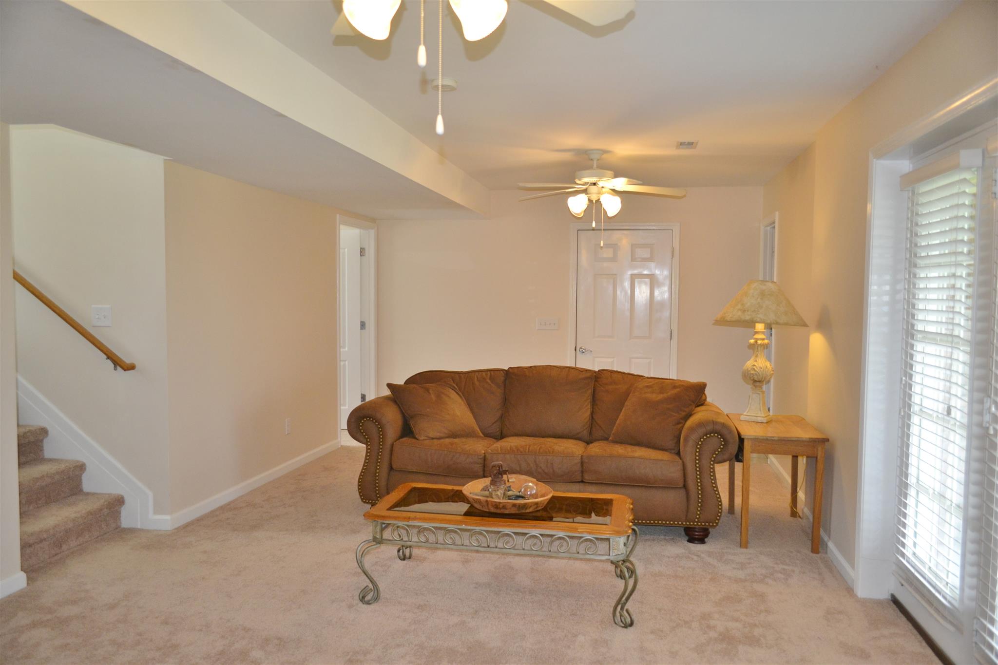 1905 Clara Mathis Road Spring Hill, TN 37174 - Photo 25 of 29 a living room with furniture and a chandelier