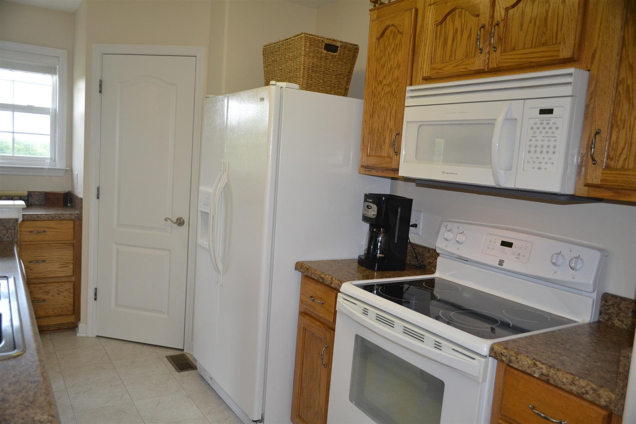 1905 Clara Mathis Road Spring Hill, TN 37174 - Photo 8 of 29 a kitchen with a refrigerator and cabinets
