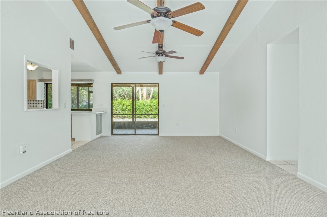 332 Oak Circle Sebring, FL 33876 - Photo 3 of 16 an empty room with windows and fan