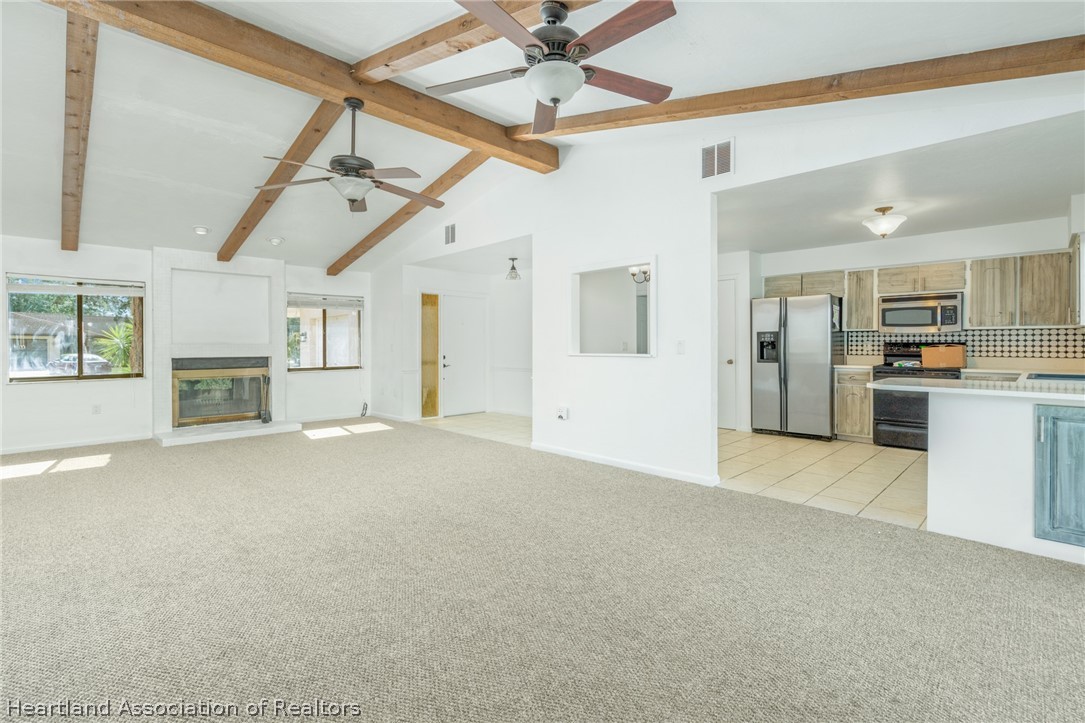 332 Oak Circle Sebring, FL 33876 - Photo 4 of 16 a view of empty room with wooden floor and a ceiling fan