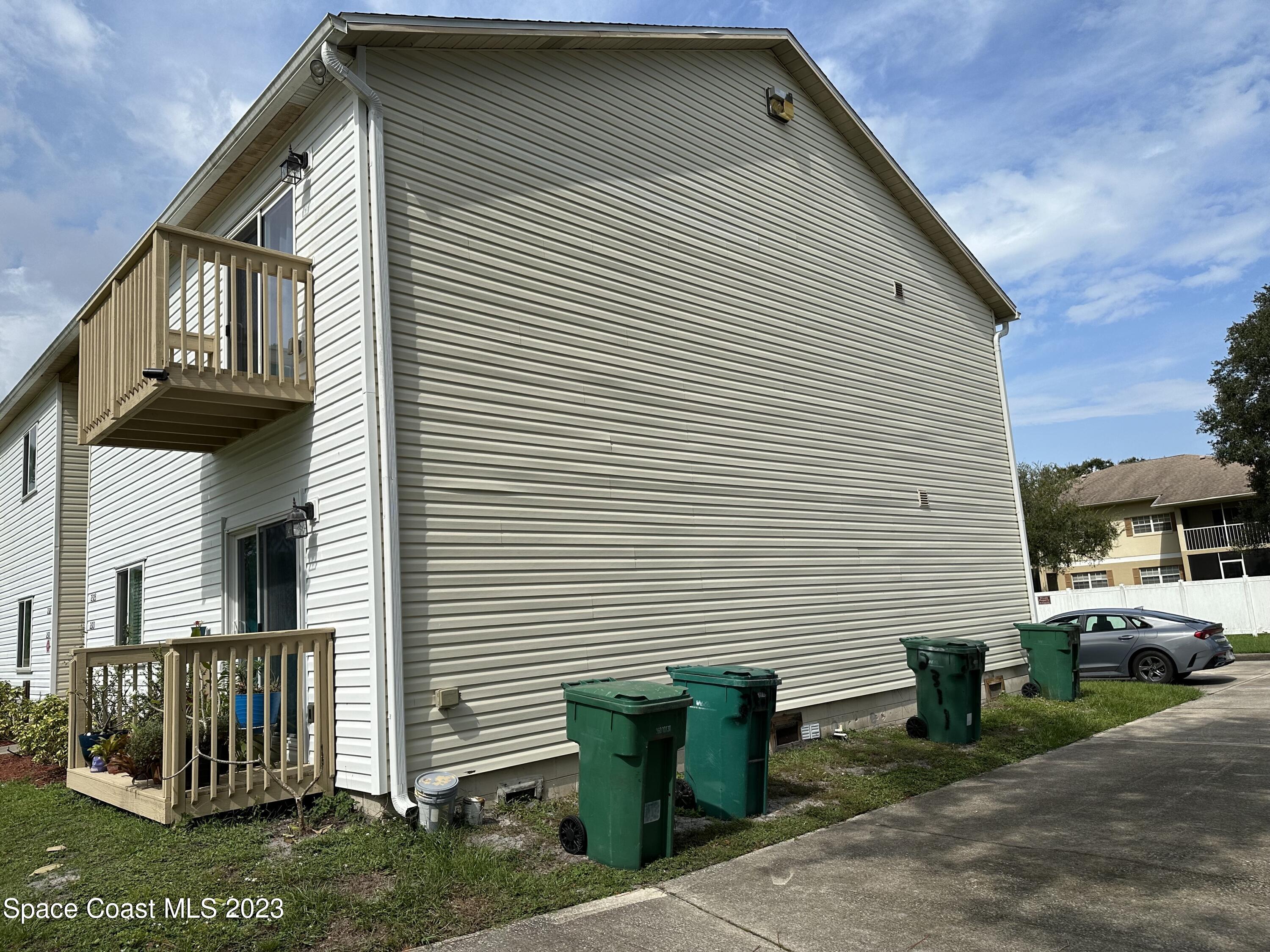 2311 Tree Ridge Lane Northeast Palm Bay, FL 32905 - Photo 2 of 4 a view of a house with a yard