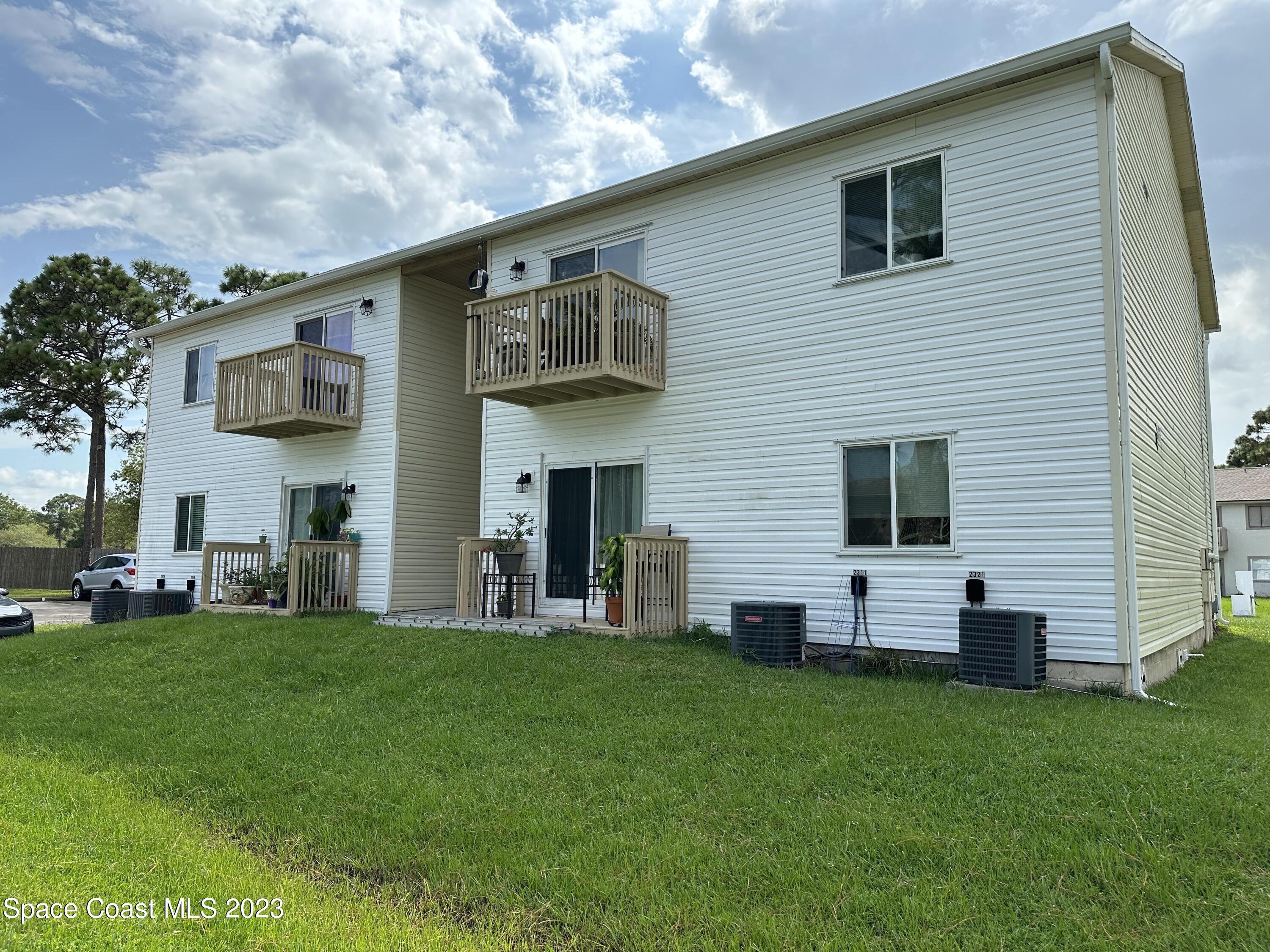 2311 Tree Ridge Lane Northeast Palm Bay, FL 32905 - Photo 3 of 4 a view of a house with a backyard