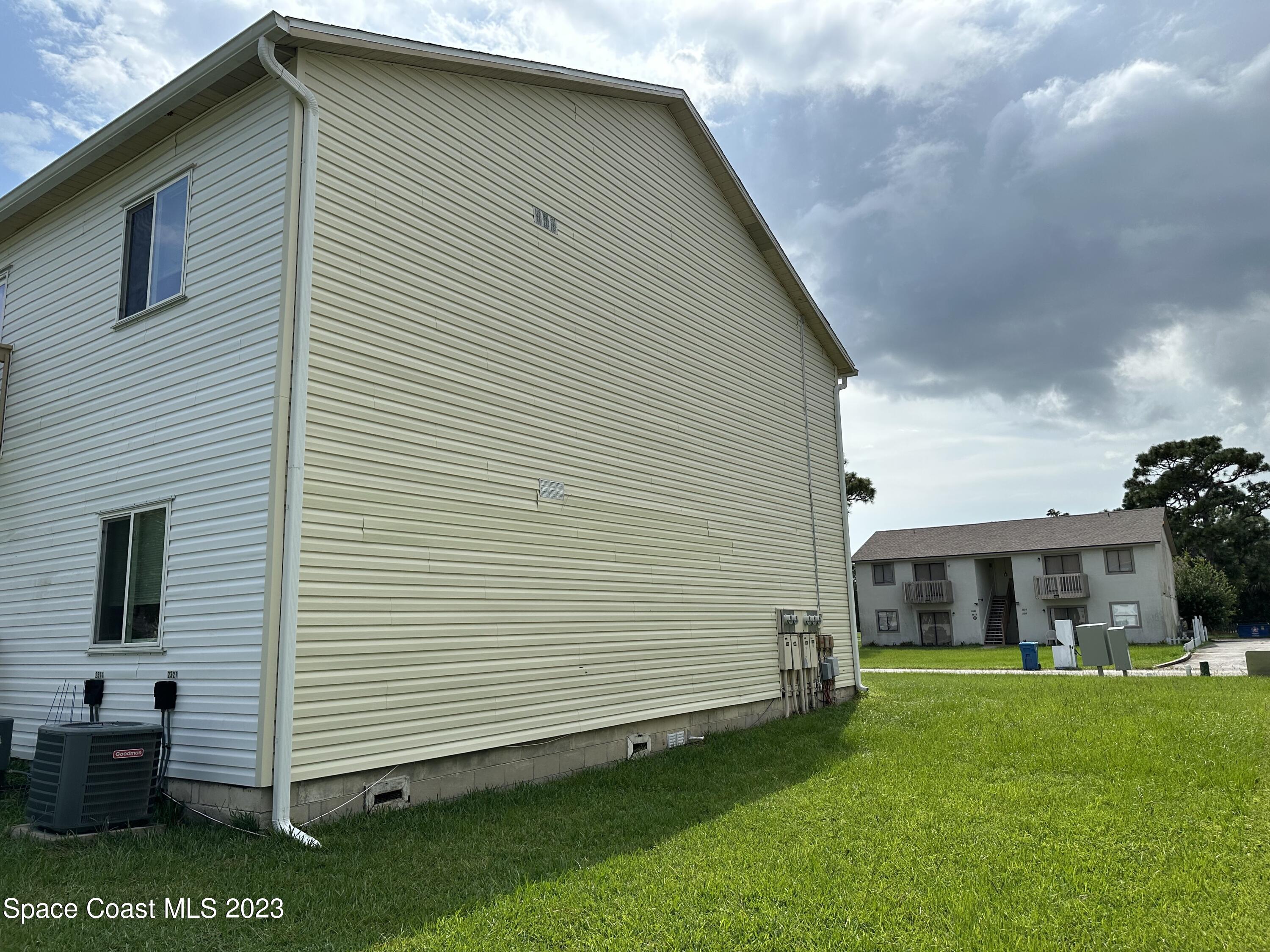 2311 Tree Ridge Lane Northeast Palm Bay, FL 32905 - Photo 4 of 4 a front view of a house with a yard