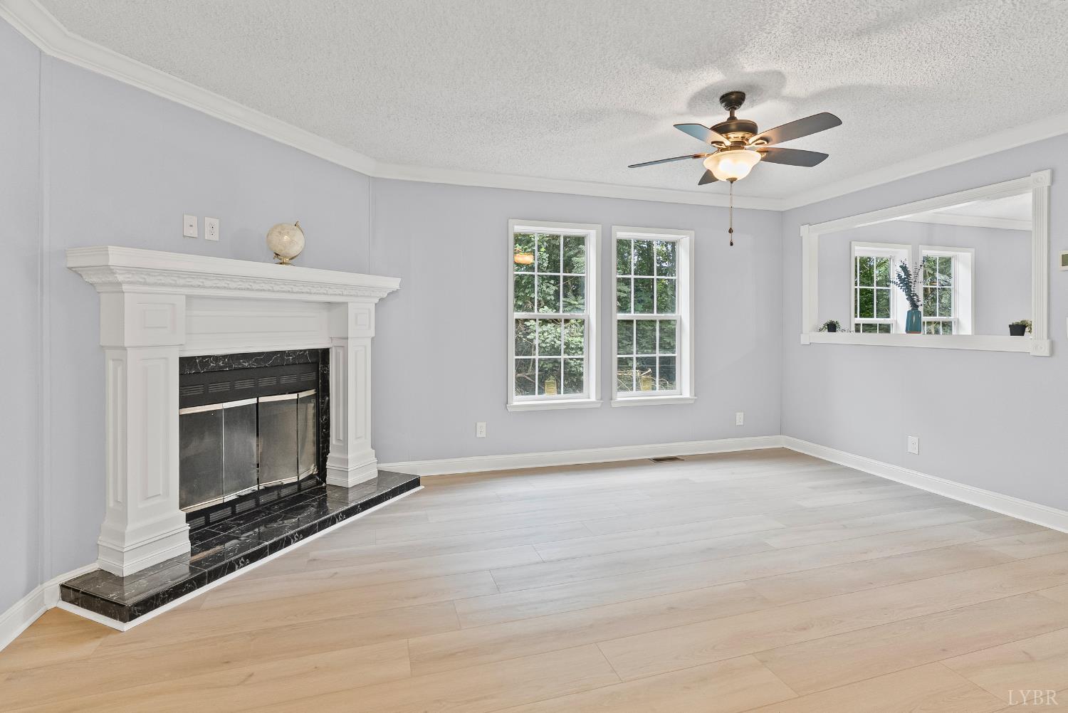 3701 Bethany Road Rustburg, VA 24588 - Photo 15 of 55 a view of an empty room with a fireplace and a window