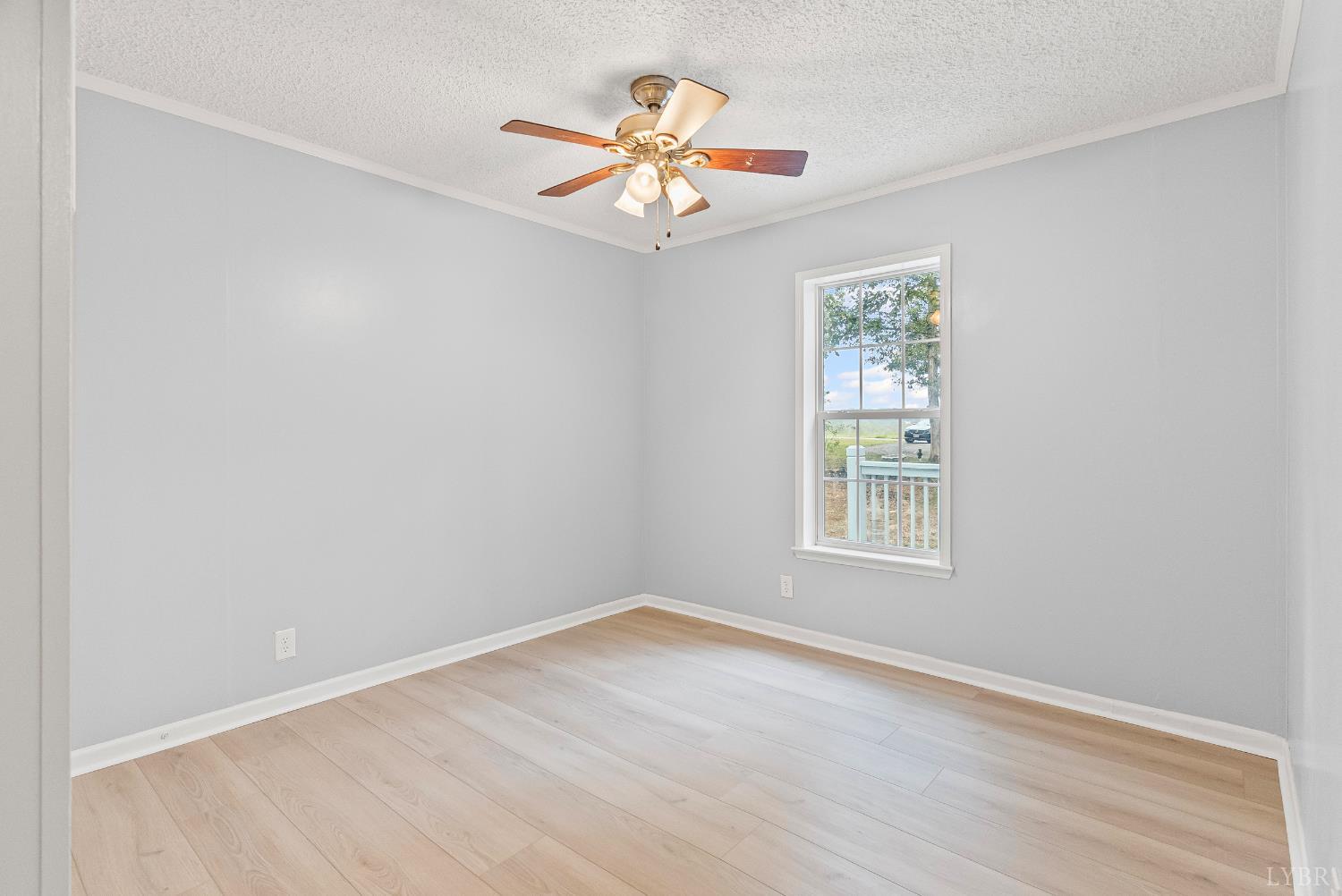 3701 Bethany Road Rustburg, VA 24588 - Photo 18 of 55 an empty room with wooden floor chandelier fan and windows