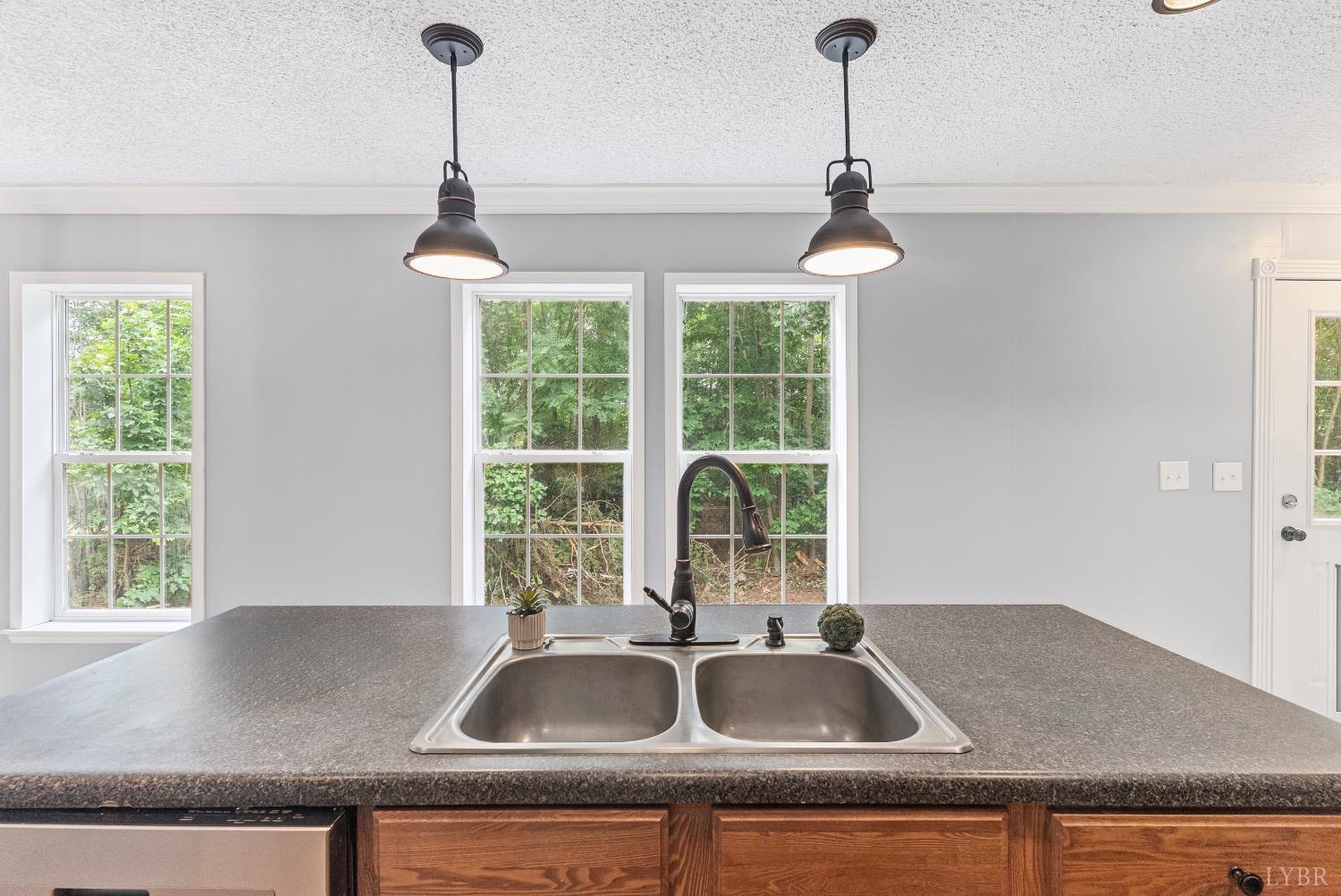 3701 Bethany Road Rustburg, VA 24588 - Photo 36 of 55 a kitchen with granite countertop a sink and a window