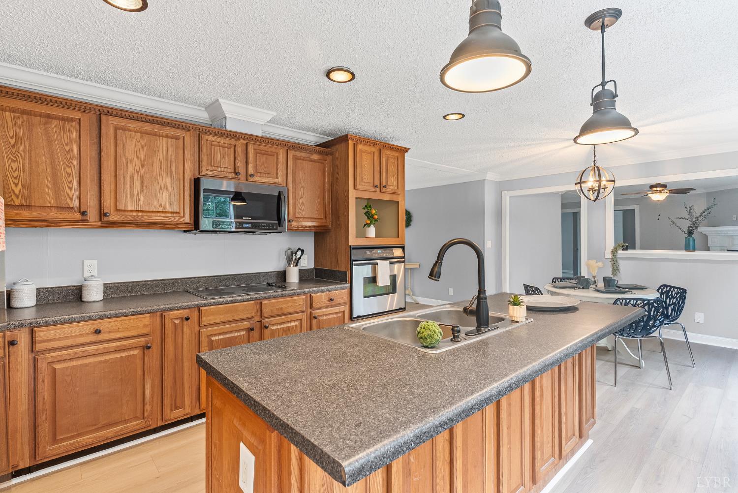 3701 Bethany Road Rustburg, VA 24588 - Photo 37 of 55 a kitchen with sink a stove and chairs