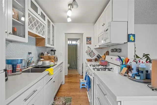 a room with furniture a refrigerator and a window