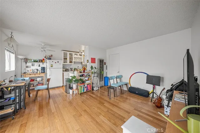 a view of a livingroom with workspace and a window