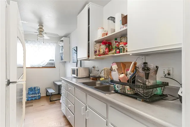 a kitchen with a stove a sink and a refrigerator