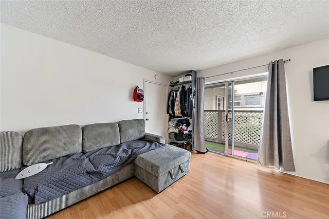 a kitchen with a stove a refrigerator and wooden floor