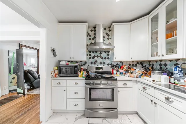 a kitchen with sink cabinets and stainless steel appliances