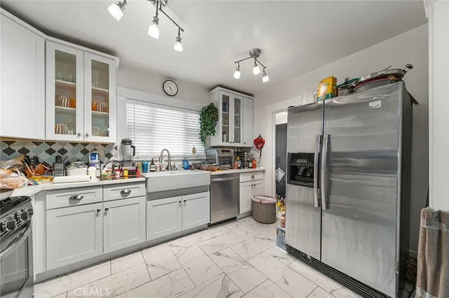a bedroom with a bed and a flat tv screen on dresser