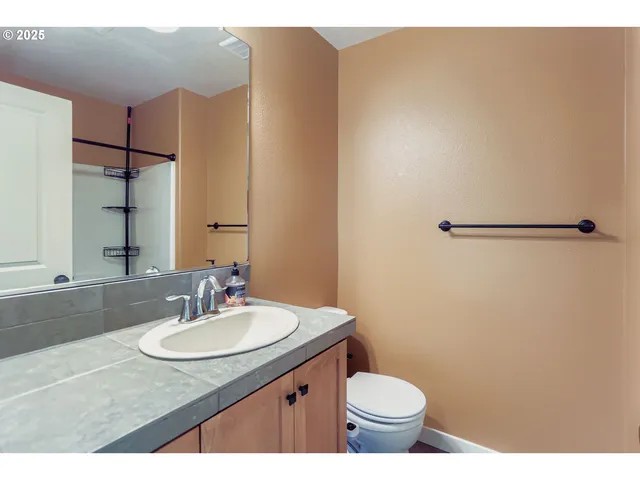 a view of a bathroom with a sink and a mirror
