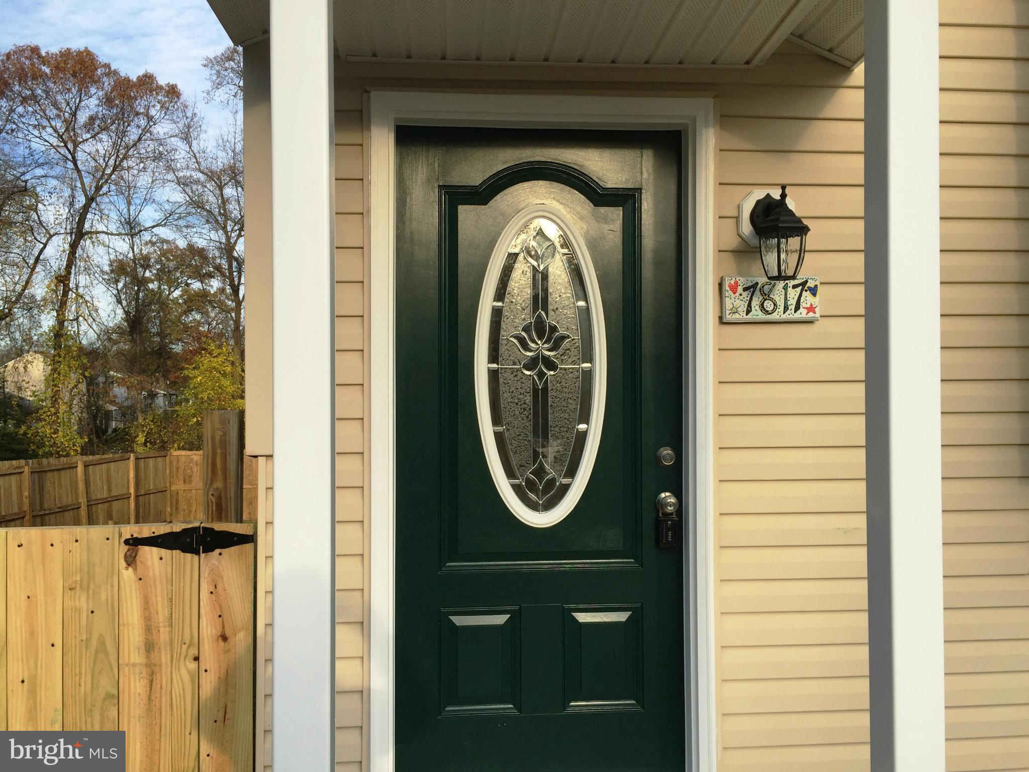 7817 Camp Road Pasadena, MD 21122 - Photo 3 of 30 a front view of a house with a door