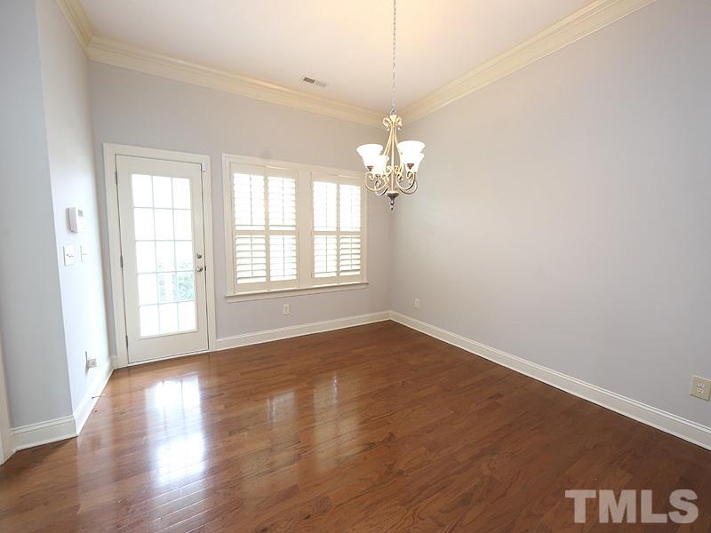 832 Historian Street Raleigh, NC 27603 - Photo 11 of 25 an empty room with wooden floor and window